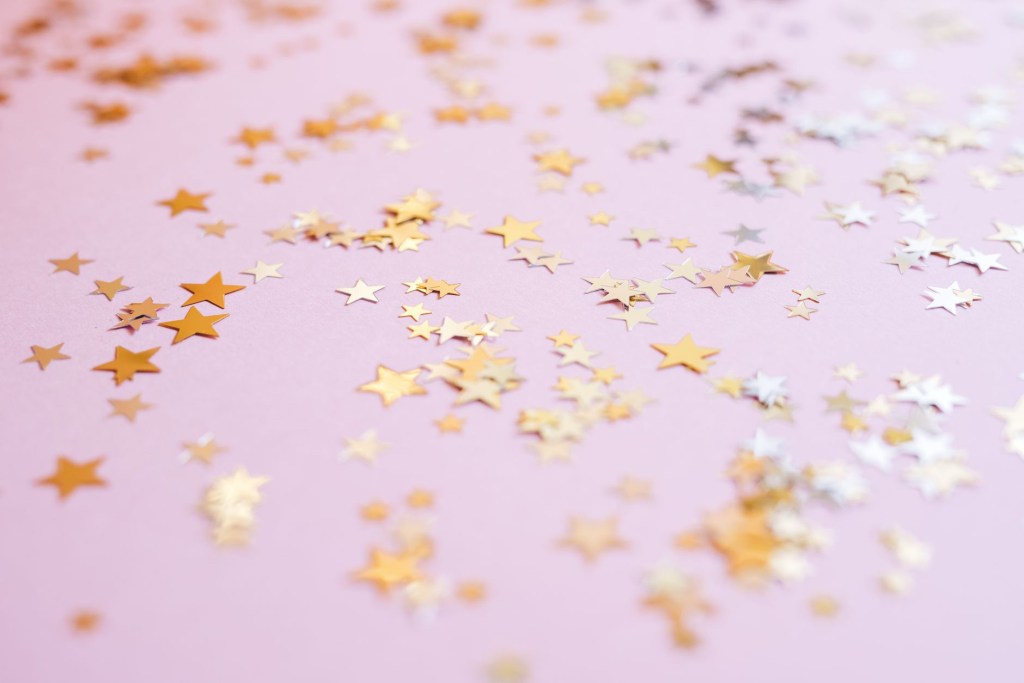 Gold star confetti with pink background